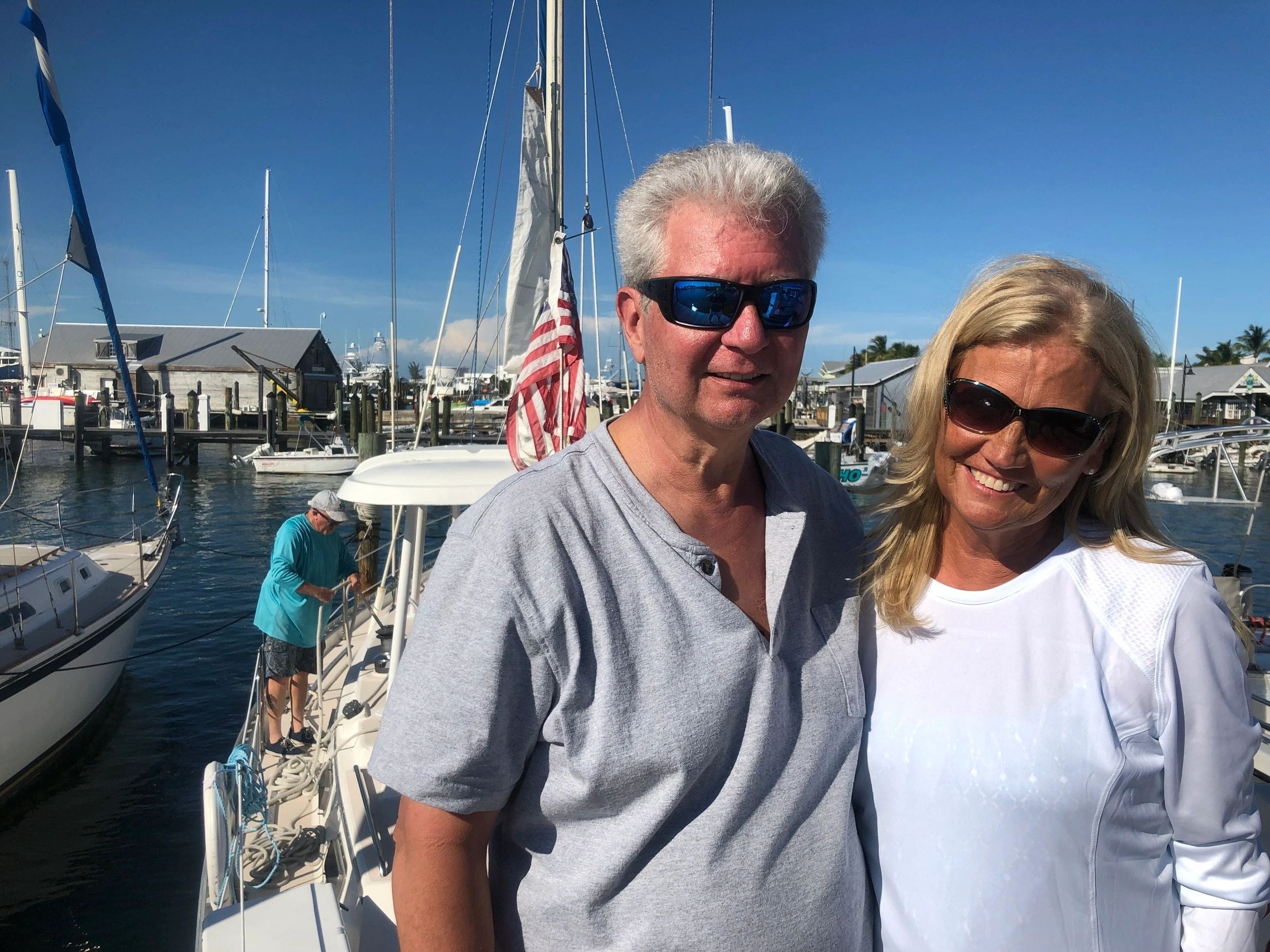 A man and woman standing on the deck of a boat.