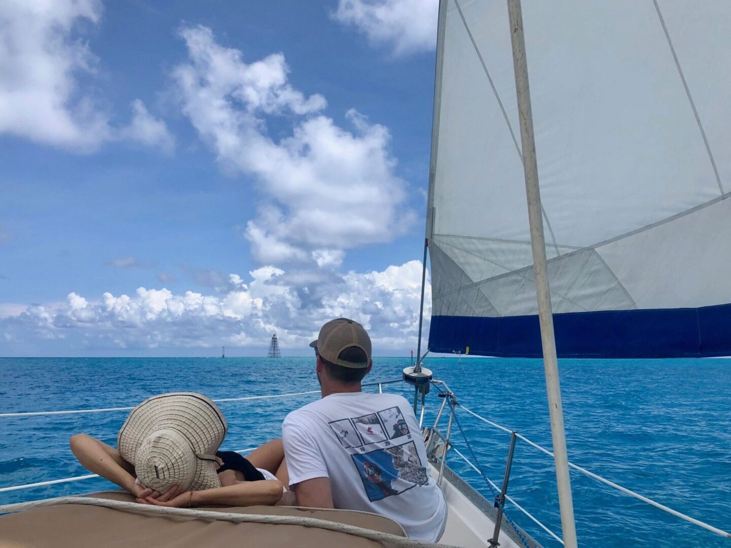 A couple of people on a boat in the ocean.