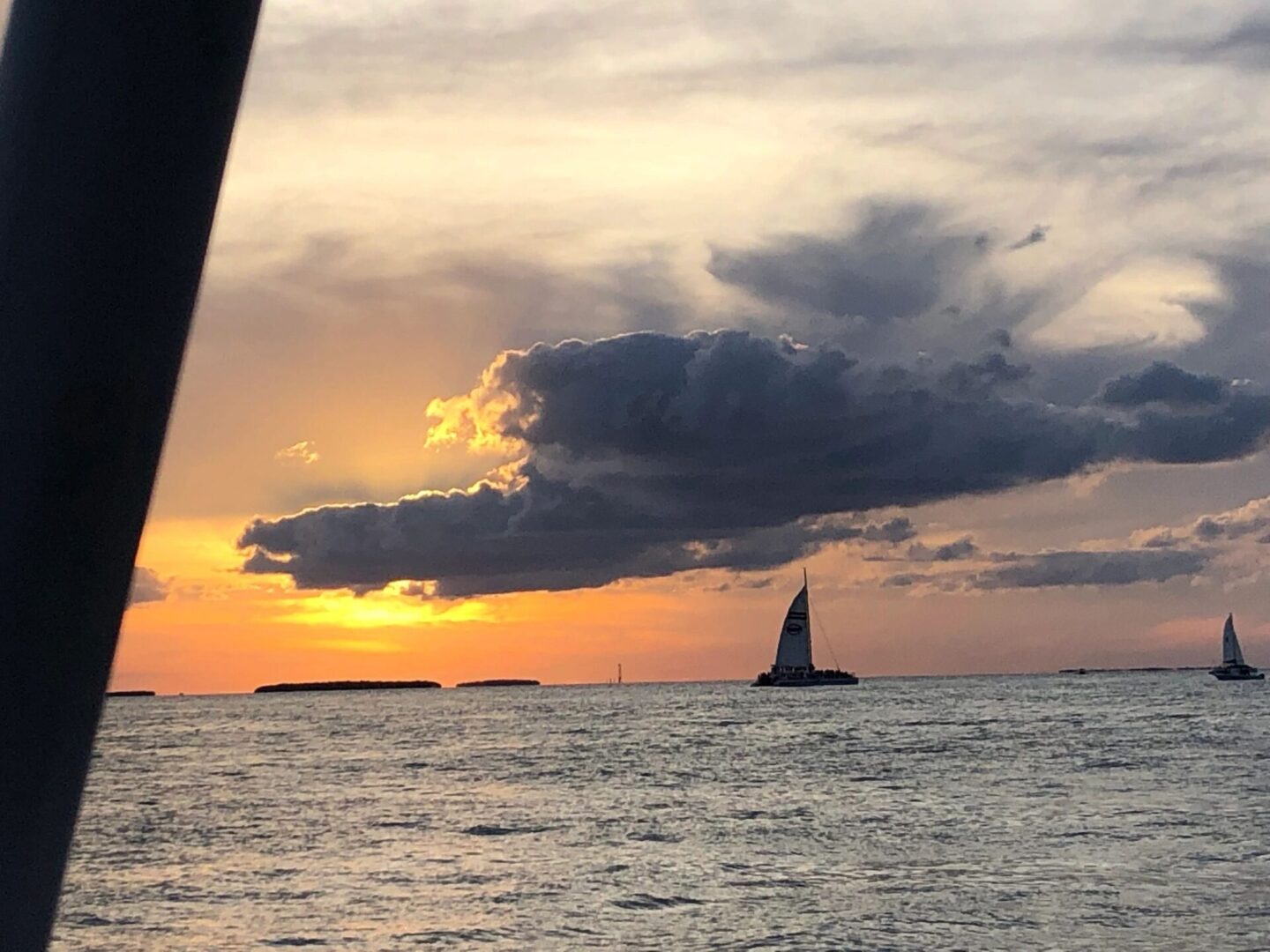 A view of the ocean from a boat at sunset.