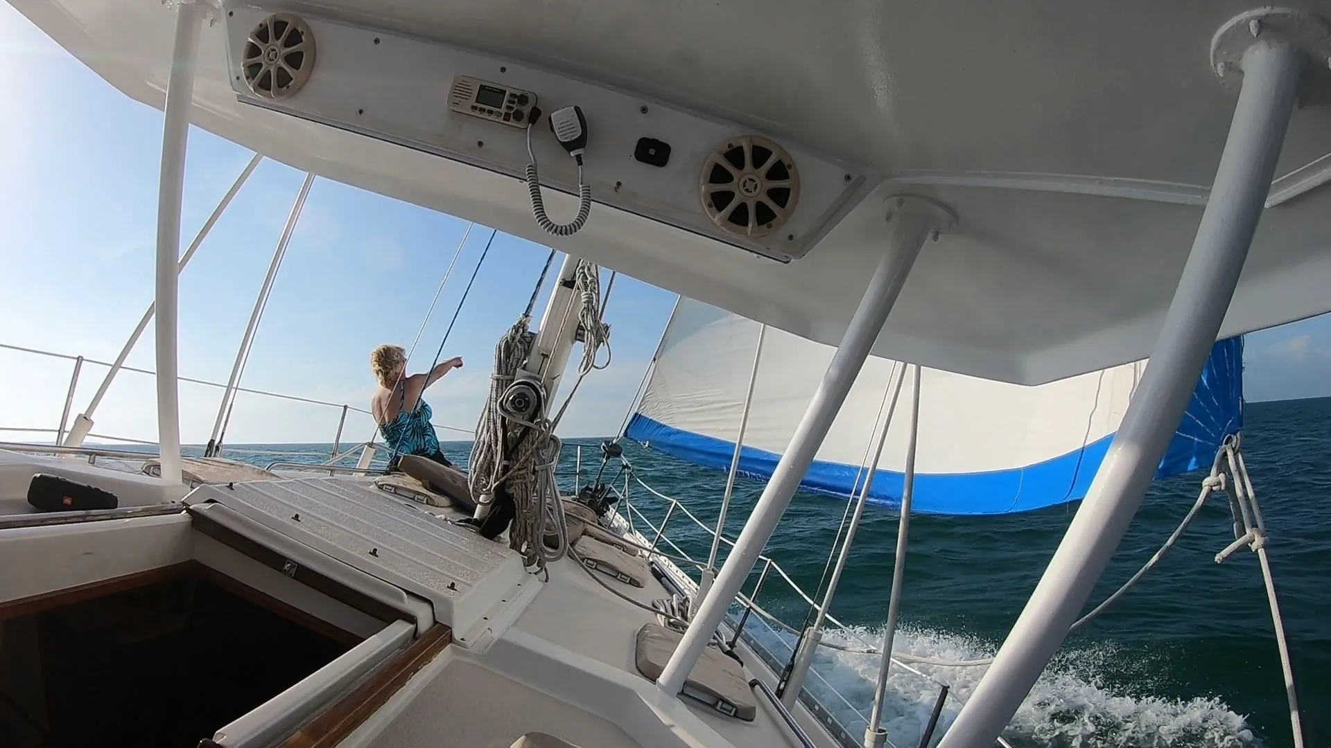 A person on the deck of a boat in the ocean.