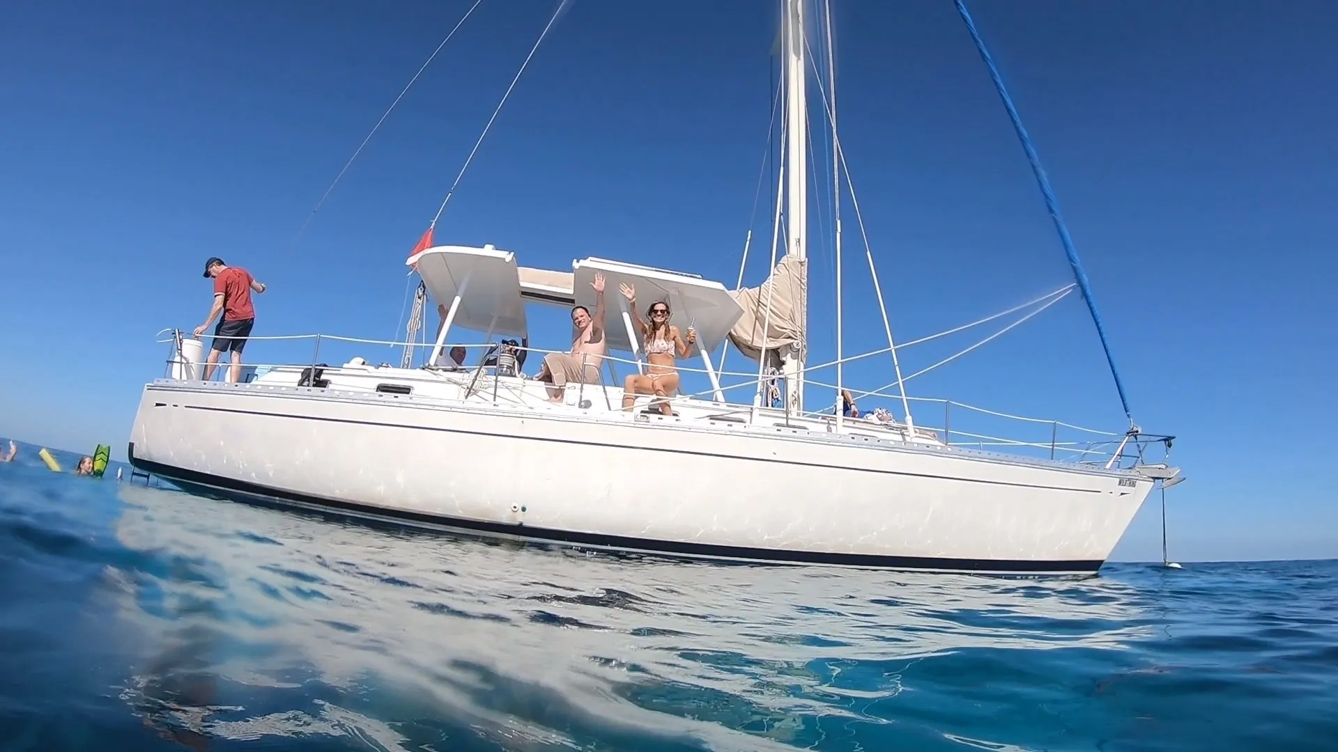 A woman in a bikini is on the front of a boat.