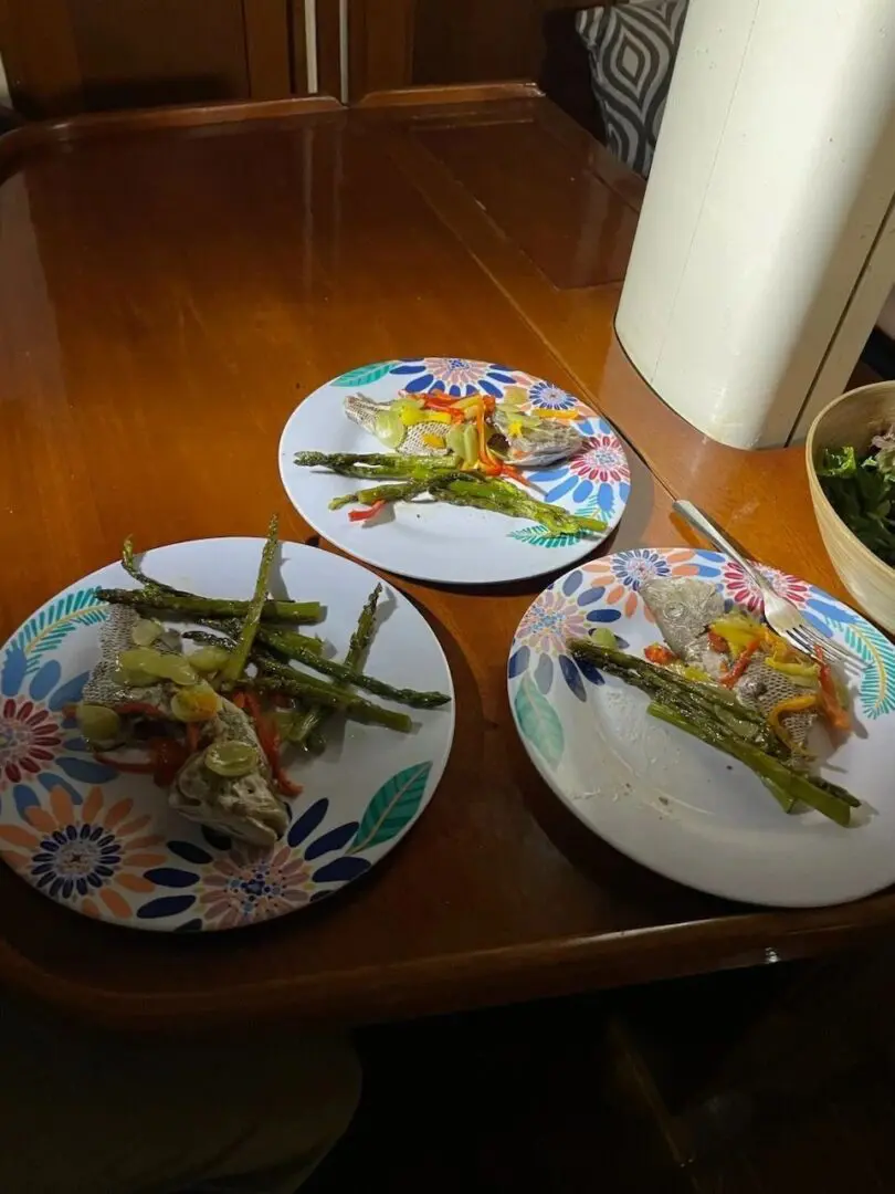 Three plates with food on them sitting on a table.