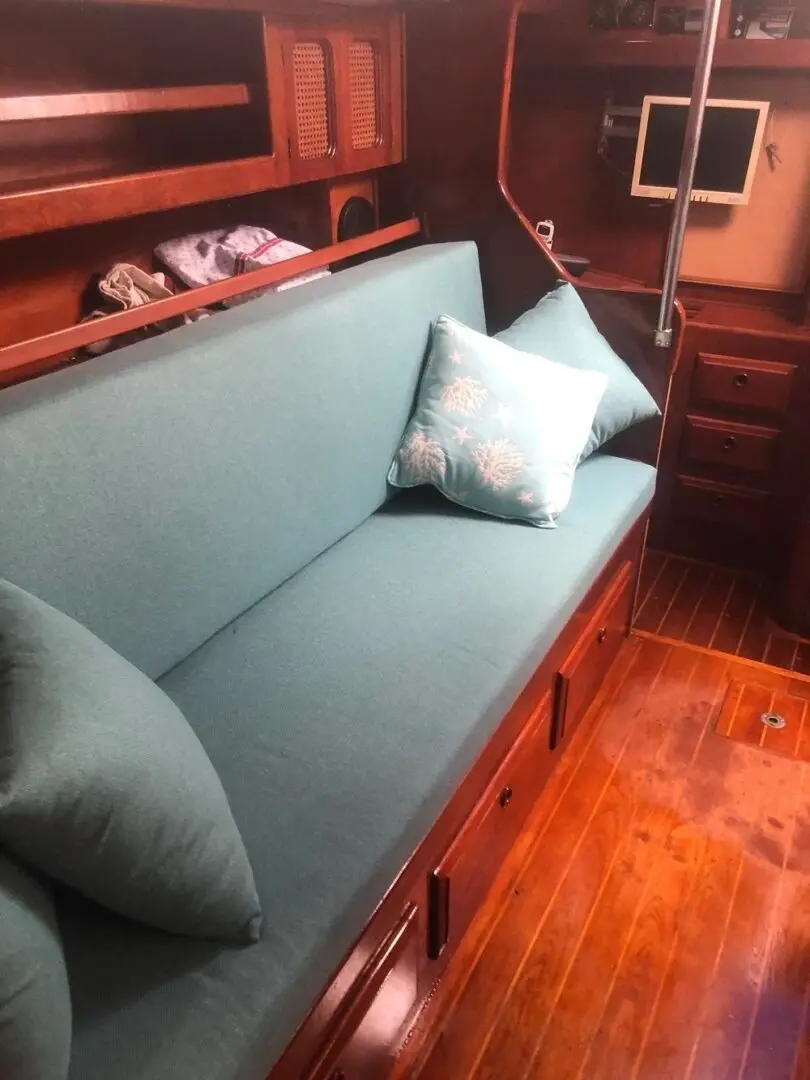 A couch with pillows on it in the middle of a room.